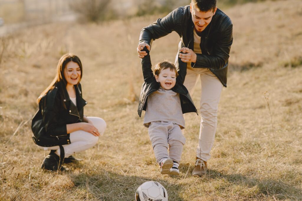 Photo of family having fun with soccer ball