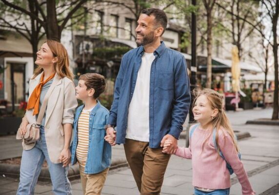 Family exploring city Happy young family on vacation. Parents and kids exploring European city.
